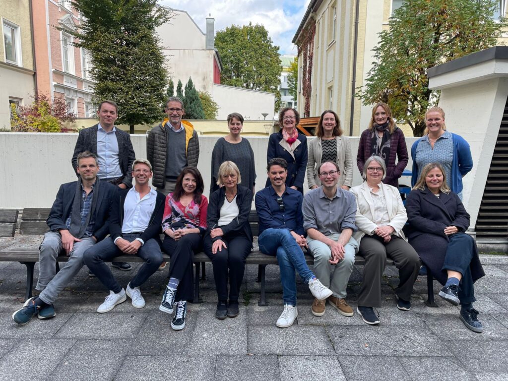 Group picture of the LaCoLA network group, taken in the backyard of a university building in Munich